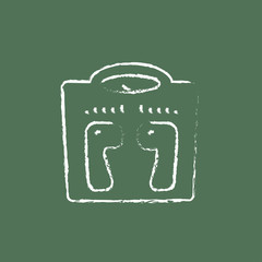 Weighing scale icon drawn in chalk.