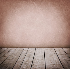 Grunge wall and wood paneled floor, interior of a room.
