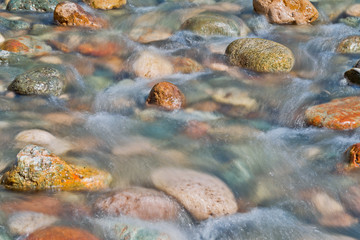 Pebble stones in the river water close up view,