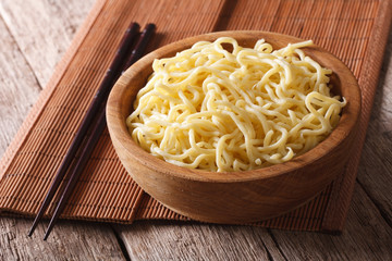 Asian ramen noodles in wooden bowl close-up. horizontal
