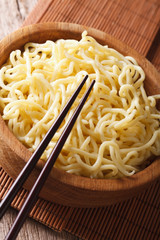 Traditional Asian ramen noodles in wooden bowl close-up. vertical
