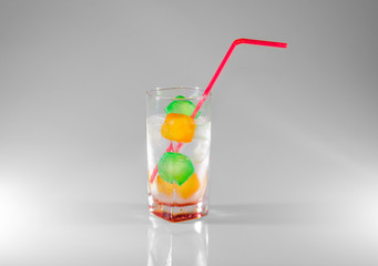 Soda with plastic colorful cubes
