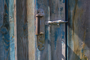 Old wooden blue door with handle