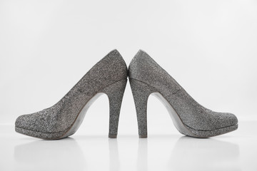 Obraz premium Womens silver high heels on white background