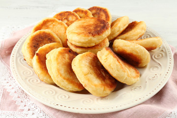Fritters of cottage cheese in plate, closeup