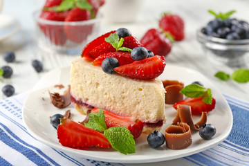 Delicious cheesecake with berries on table close up