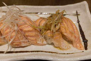 Assorted Salmon Suhi on white ceramic plate