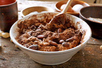 Preparing dough for chocolate pie on table close up