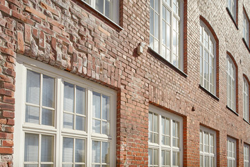 Fototapeta na wymiar Brick wall and windows. Architecture details of an old building.