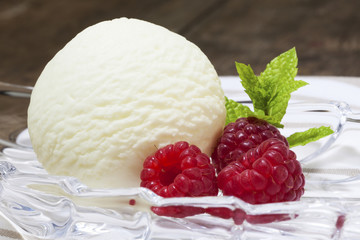 Vanilla ice cream scoop with raspberries