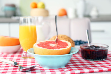 Healthy breakfast with fruits and berries on table in kitchen