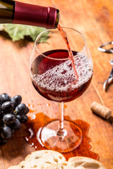 Red wine against wooden background
