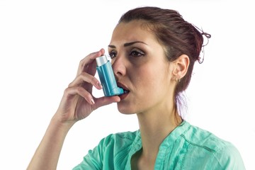 Close-up of woman using asthma inhaler  - obrazy, fototapety, plakaty