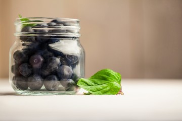 Glass jar of fresh blueberries