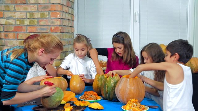 Children And Adults Cleaning Halloween Pumpkins