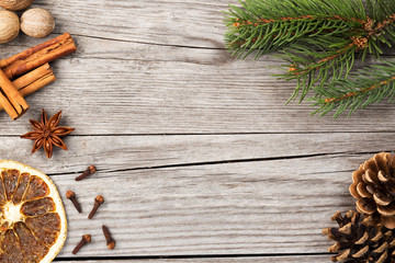 spices and fir branch on wooden background
