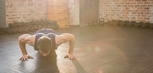 Handsome man doing wide arm push ups