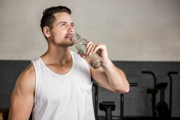 Fototapeta na wymiar Muscular man holding bottle