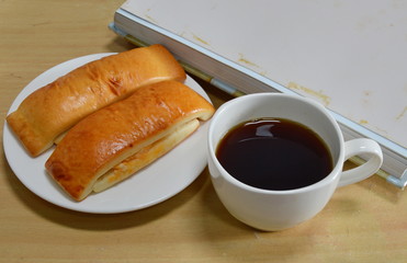bread stick and black coffee with photo album