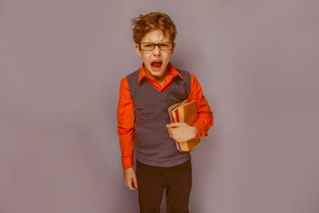 European-looking  boy of ten years in glasses opened his mouth s