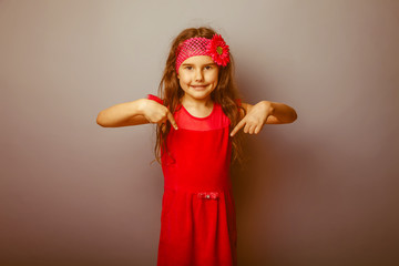 Girl European appearance haired child of seven in red bright dre