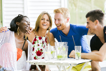 Happy young people laughing a being happy at a table