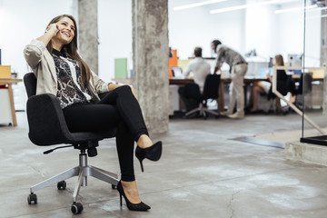 Confident business woman using phone