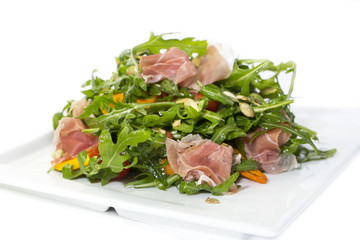 salad of arugula ham cheese on a white background