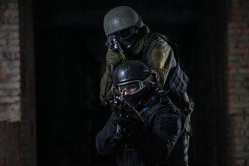 Fully equipped military men with automatic weapons playing