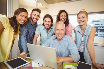 Portrait of confident business people with technologies