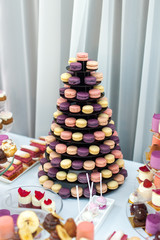 Sweet pyramid of the colorful french macaroons for the birthday, event or wedding