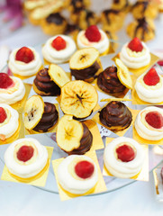 Sweet desserts with strawberries and bananas on the plate for the birthday, event or wedding