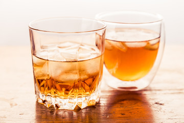 Two different glasses of whiskey 