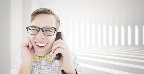 Composite image of geeky hipster holding a retro cellphone
