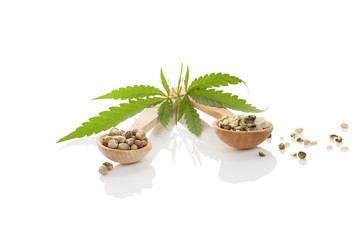 Cannabis seeds on wooden spoon.
