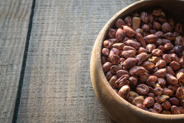  peanuts or groundnuts in wooden bowl