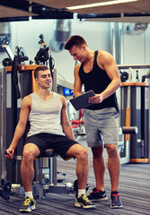 men exercising on gym machine
