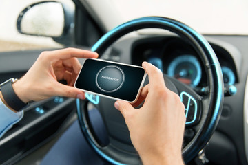 hands with navigator on smartphone in car