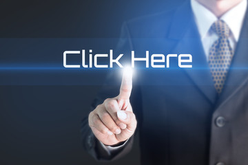 Business man pointing at CLICK HERE word for business background concept