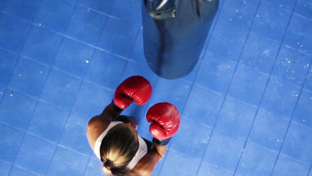 Athletic Woman Boxing Fitness Training in Gym. Punching Body Bag Shot From Above Looking Down. Women Freedom Healthy Active Lifestyle.