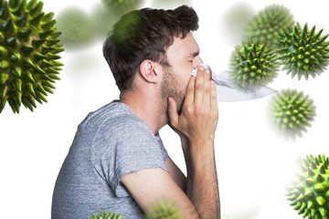 Composite image of close up side view of man blowing nose