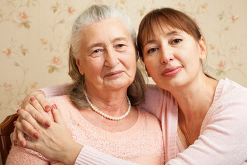 Senior woman with their caregiver at home.