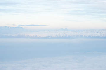 Above the clouds aerial view of snowcapped andes mountains