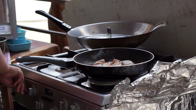 Frying steak in a frying pan