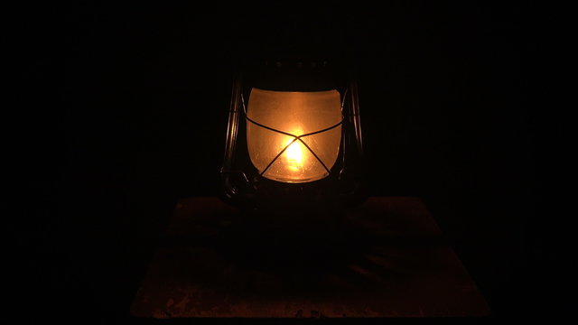 Oil lamp lit in the darkness. 4K.