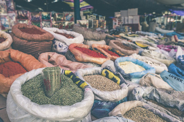 Vivid oriental central asian market with bags full of various sp
