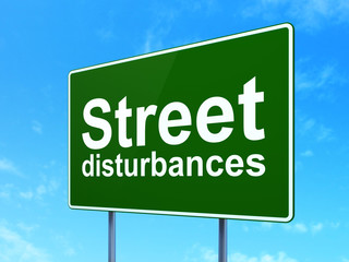 Politics concept: Street Disturbances on road sign background