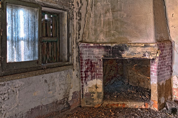 image of an old abandoned room with fireplace and window