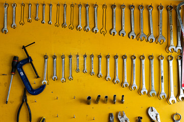 Tools Hanging on a yellow board wall