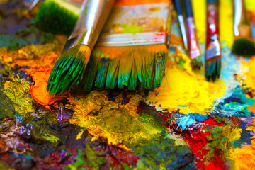 Paint brushes to the painting palette with colors 